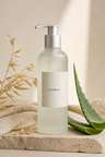 Meadow Dew Gel Cleanser in a frosted pump bottle on a pale stone surface