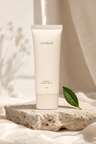 Sunfield Mineral SPF 30 tube resting against smooth river stones